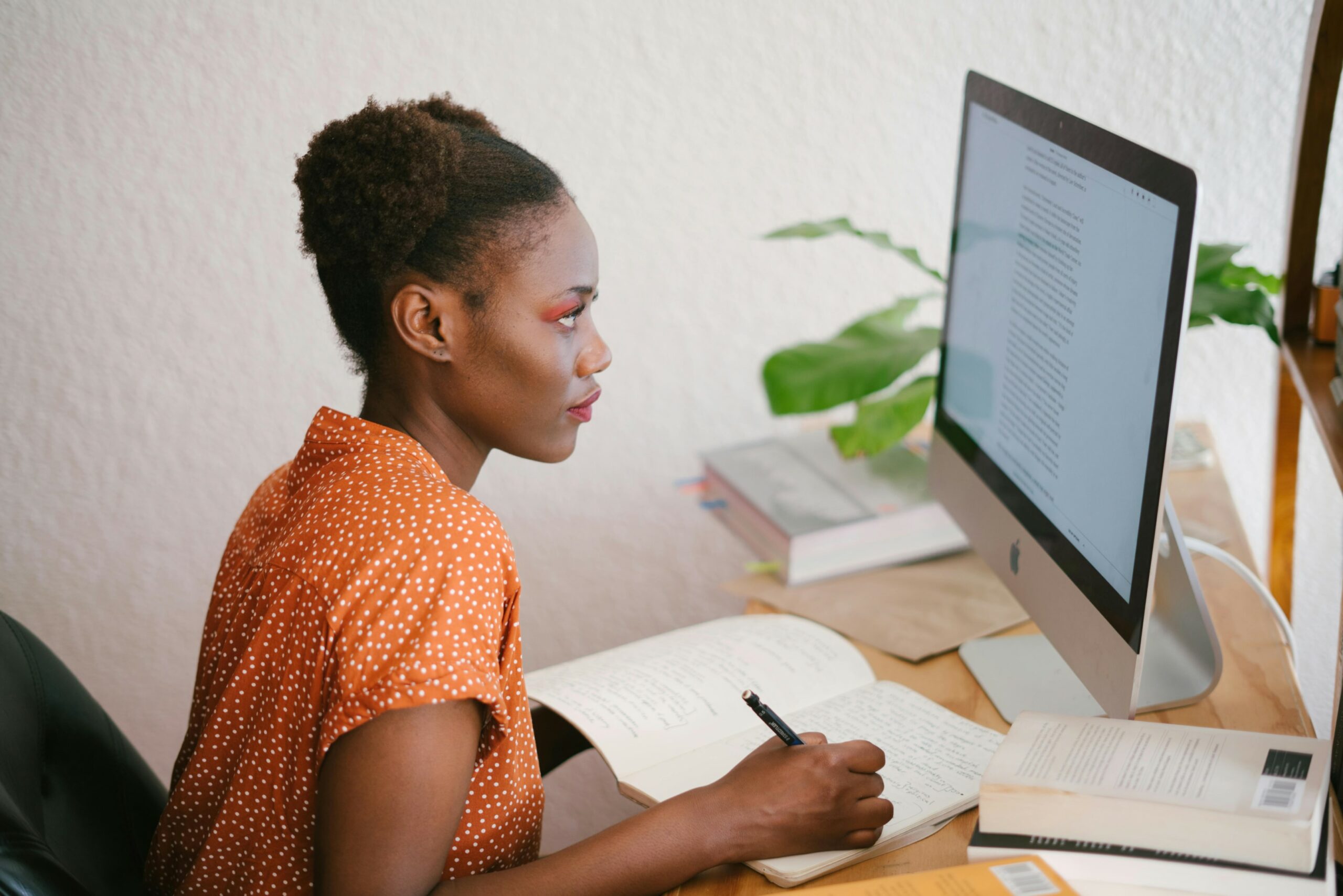 Woman at desk taking notes during training