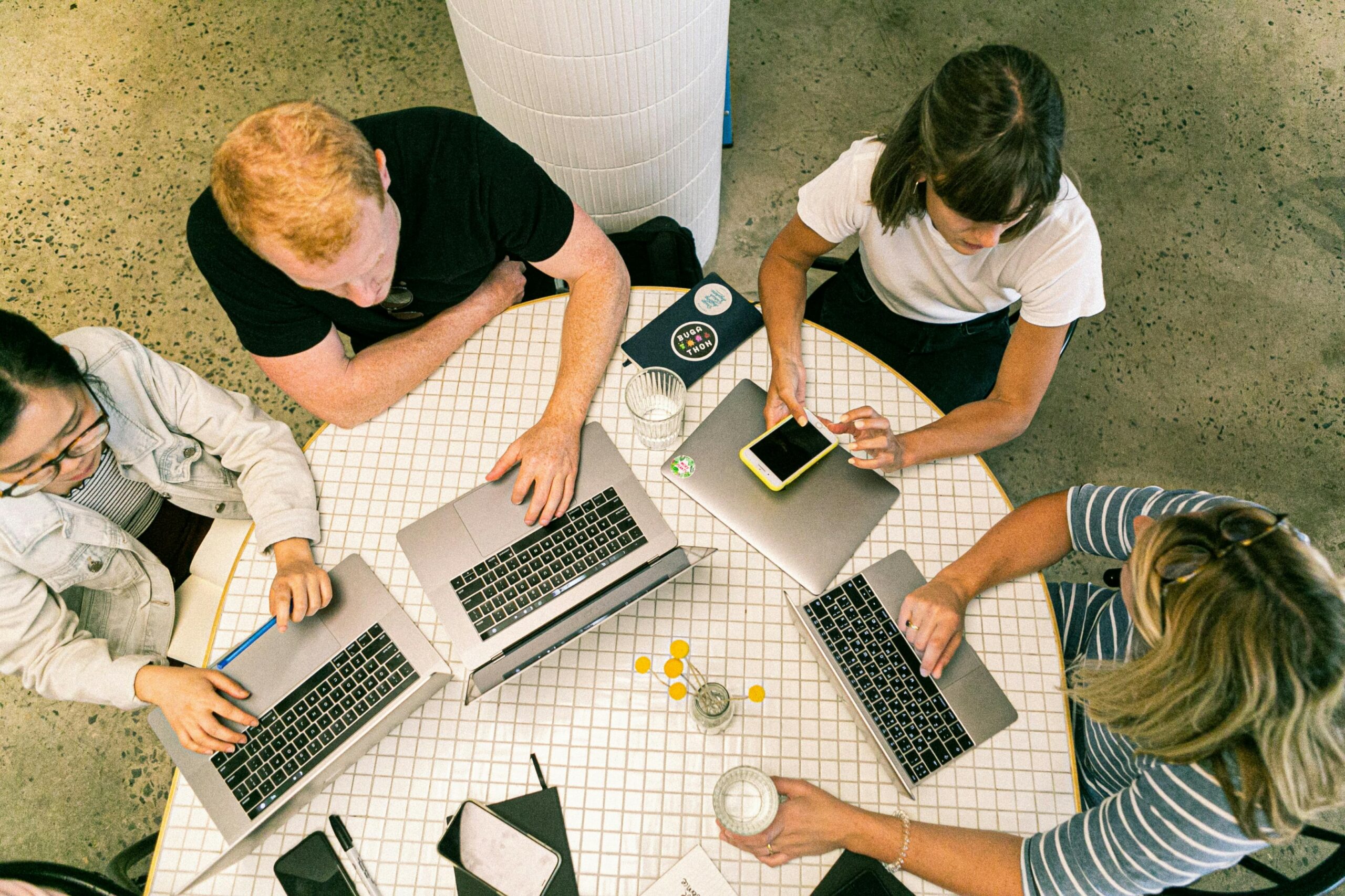 Group of people working together on laptops