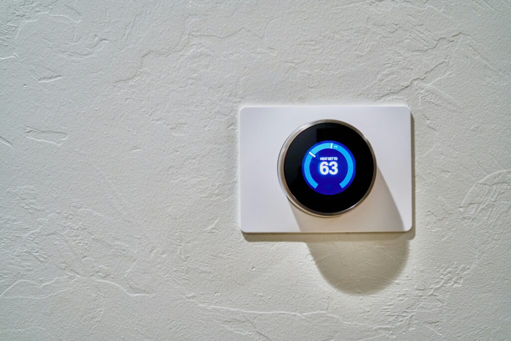Wall-mounted thermostat set to 63oF