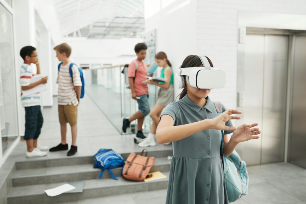 A girl playing with a white virtual reality headset in a school hallway