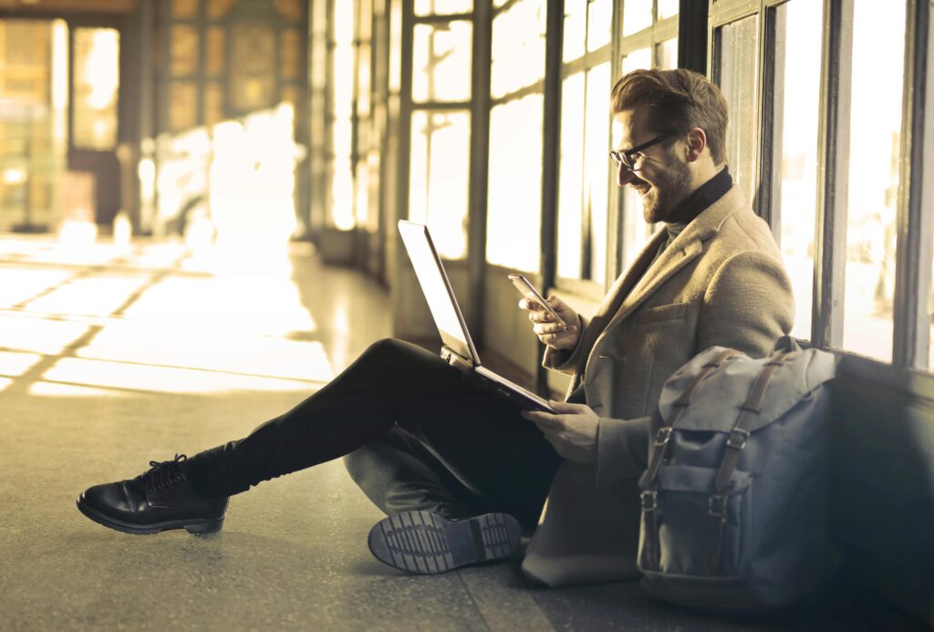 man with iphone working remotely