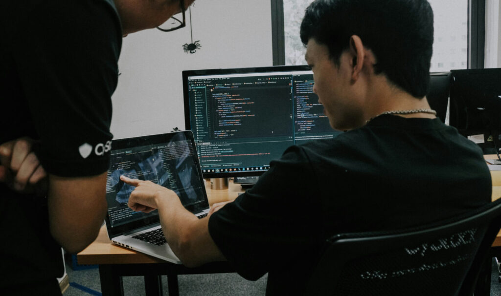 Two people working on computers in an office