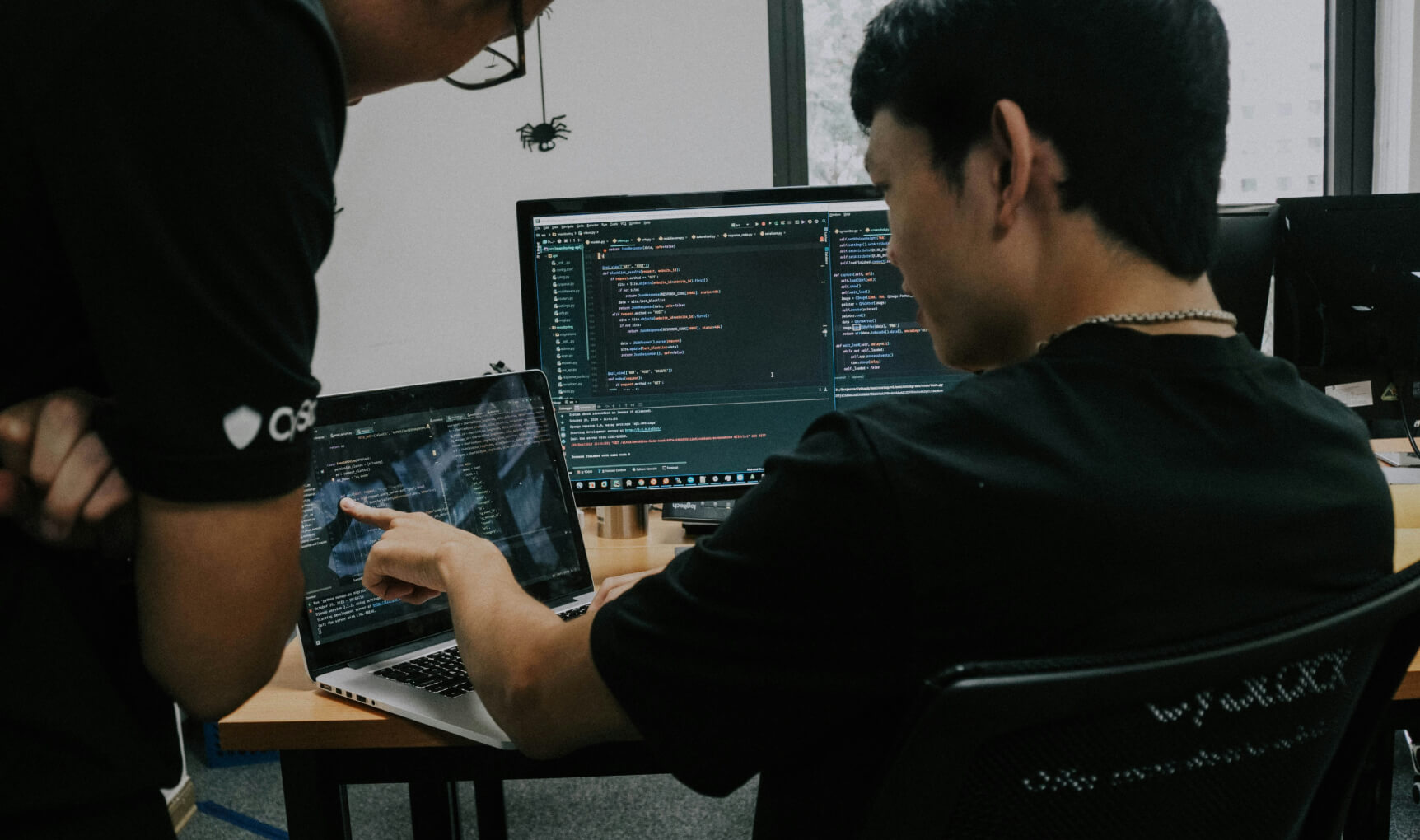 Two people working on computers in an office