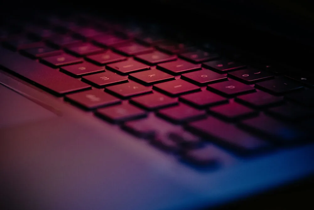 Close-up of a backlit laptop keyboard