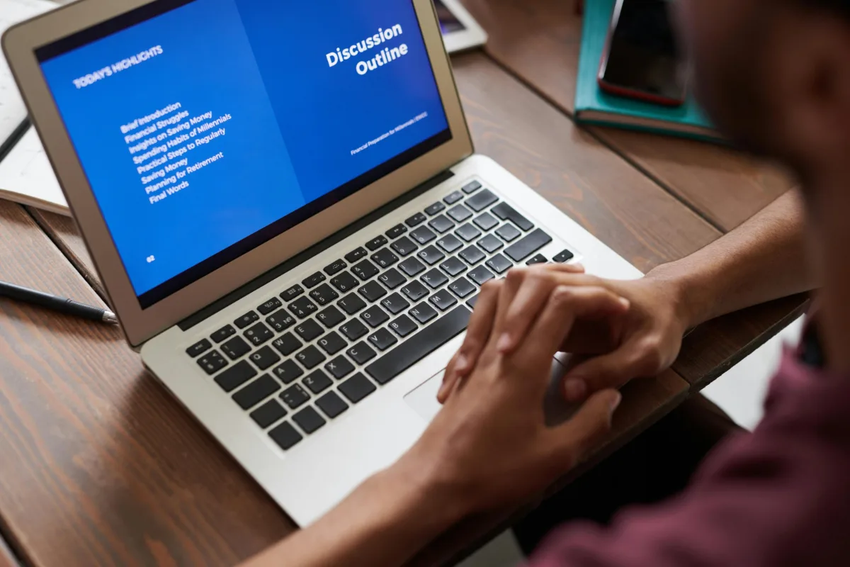Laptop displaying a discussion outline presentation during a team meeting