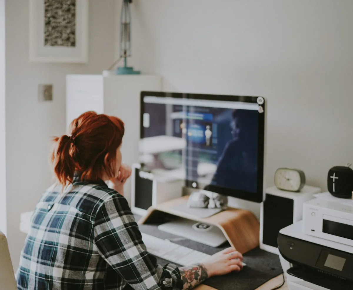 A woman working from home on a desktop PC